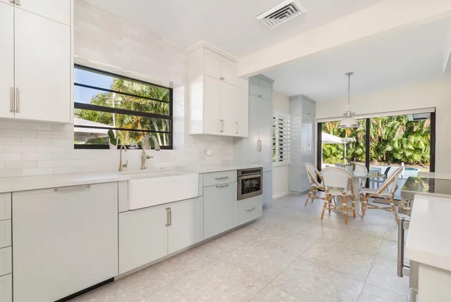 a kitchen with appliances cabinets and chair