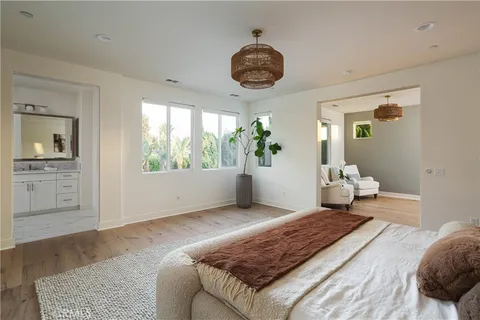 a bedroom with a large bed and a large window