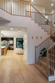 a view of a living room and entryway with wooden floor