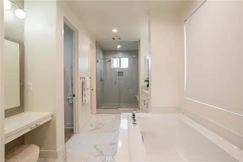 a bathroom with a tub shower and sink