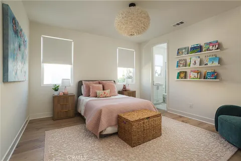 a bedroom with a large bed and a chandelier