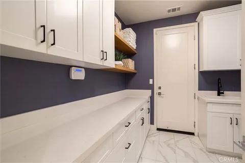 a kitchen with a white cabinets and a stove