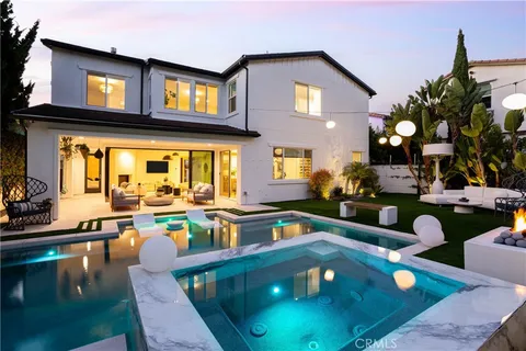 a living room with lots of furniture and a dining table with wooden floor