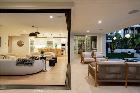 a living room with furniture and a floor to ceiling window
