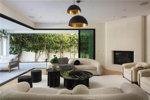 a living room with furniture and a floor to ceiling window