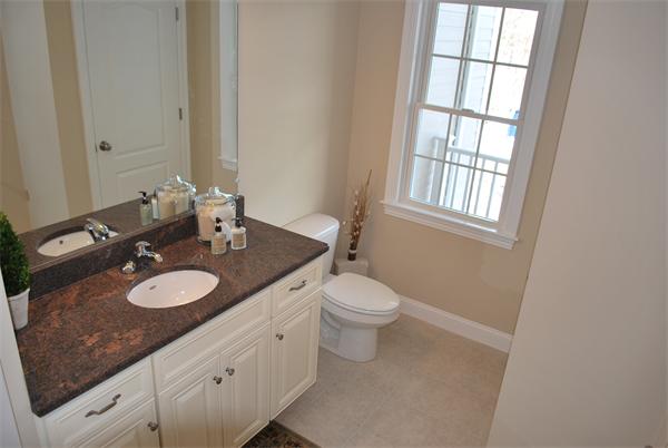 15 Littleton Road, Unit 2B Harvard, MA 01451 - Photo 13 of 29 a bathroom with a granite countertop sink toilet mirror vanity and a window