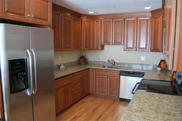 15 Littleton Road, Unit 2B Harvard, MA 01451 - Photo 4 of 29 a kitchen with stainless steel appliances granite countertop a refrigerator a sink dishwasher and wooden cabinets with a granite countertops