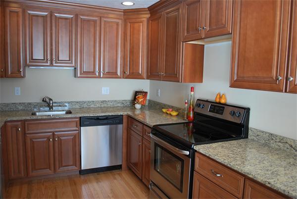 15 Littleton Road, Unit 2B Harvard, MA 01451 - Photo 5 of 29 a kitchen with granite countertop a sink stove and cabinets