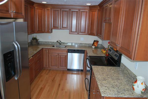 15 Littleton Road, Unit 2B Harvard, MA 01451 - Photo 6 of 29 a kitchen with stainless steel appliances granite countertop a sink a stove and a refrigerator