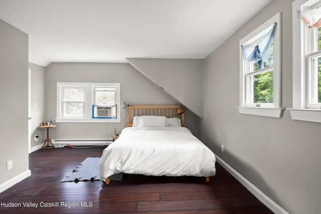 a bedroom with a bed lamps and window