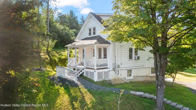 a view of a house with backyard porch and sitting area