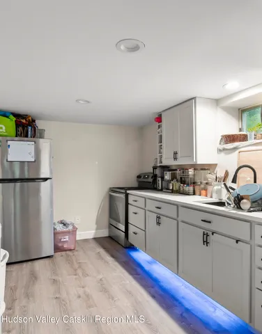 a kitchen with a sink cabinets and stainless steel appliances