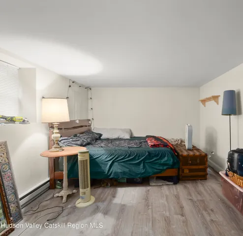 a living room with a bed furniture and a window