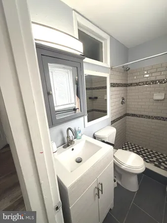 a kitchen with granite countertop a sink stove and cabinets