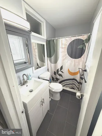 a bathroom with a sink a toilet and mirror