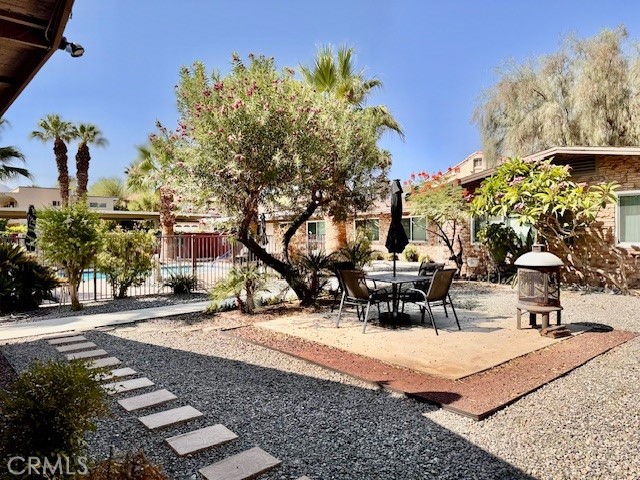 74402 Abronia, Unit 7 Palm Desert, CA 92260 - Photo 13 of 15 a view of a patio with table and chairs and potted plants