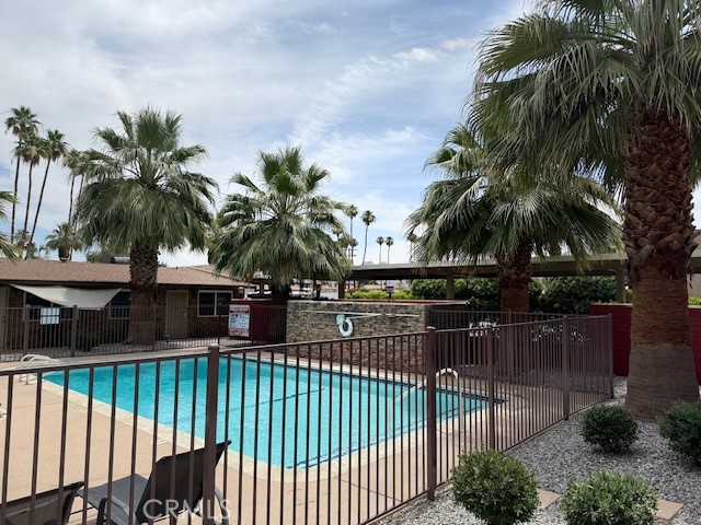 74402 Abronia, Unit 7 Palm Desert, CA 92260 - Photo 4 of 15 a view of outdoor space with swimming pool and chair