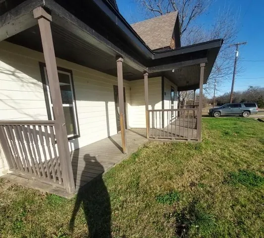 a backyard of a house with a garden and deck