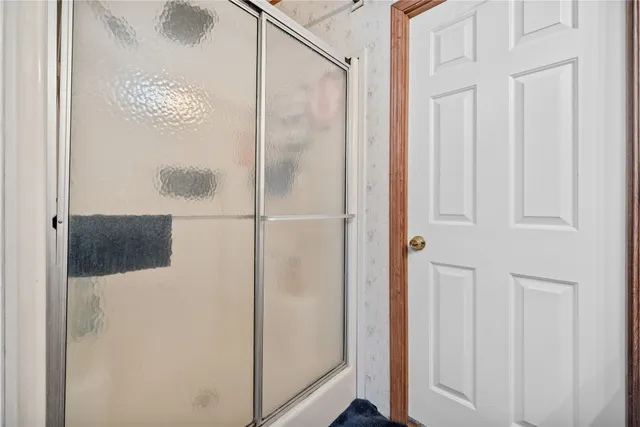 a bathroom with a glass shower door