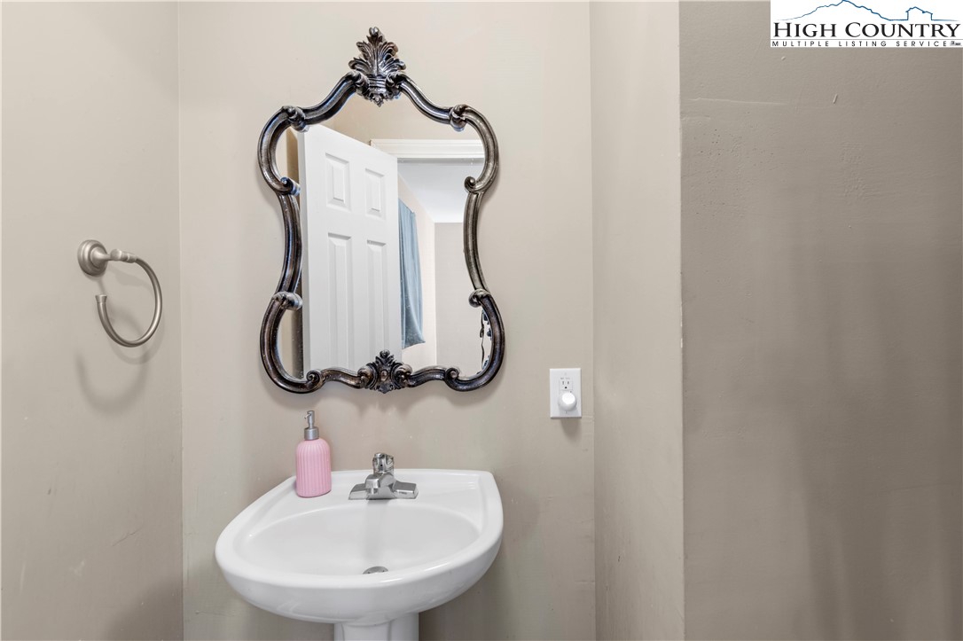 133 South Street Elkin, NC 28621 - Photo 12 of 24 a bathroom with a mirror and a sink