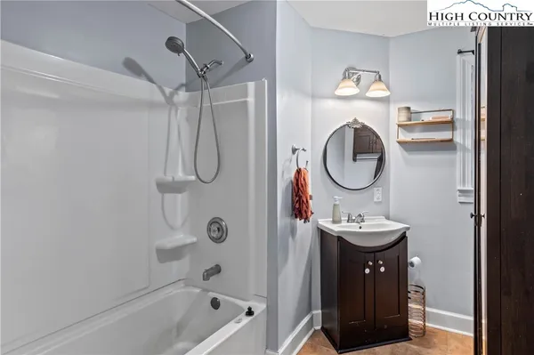 a bathroom with a sink a mirror and a shower