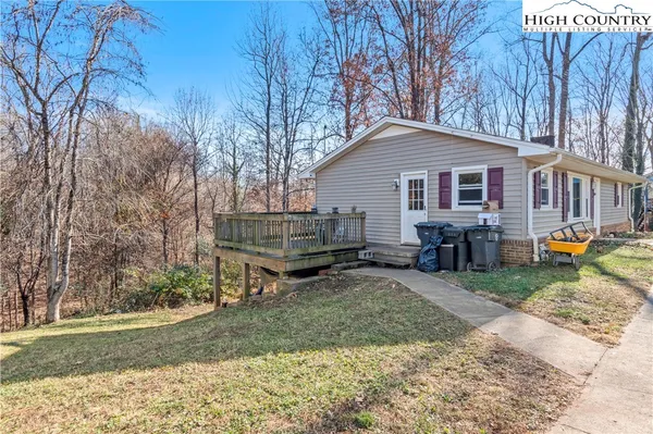 a backyard of a house with wooden fence and trees