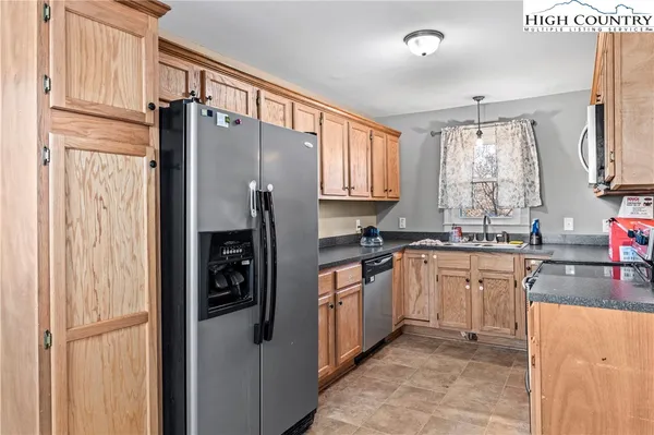 a kitchen with stainless steel appliances granite countertop a refrigerator and a sink