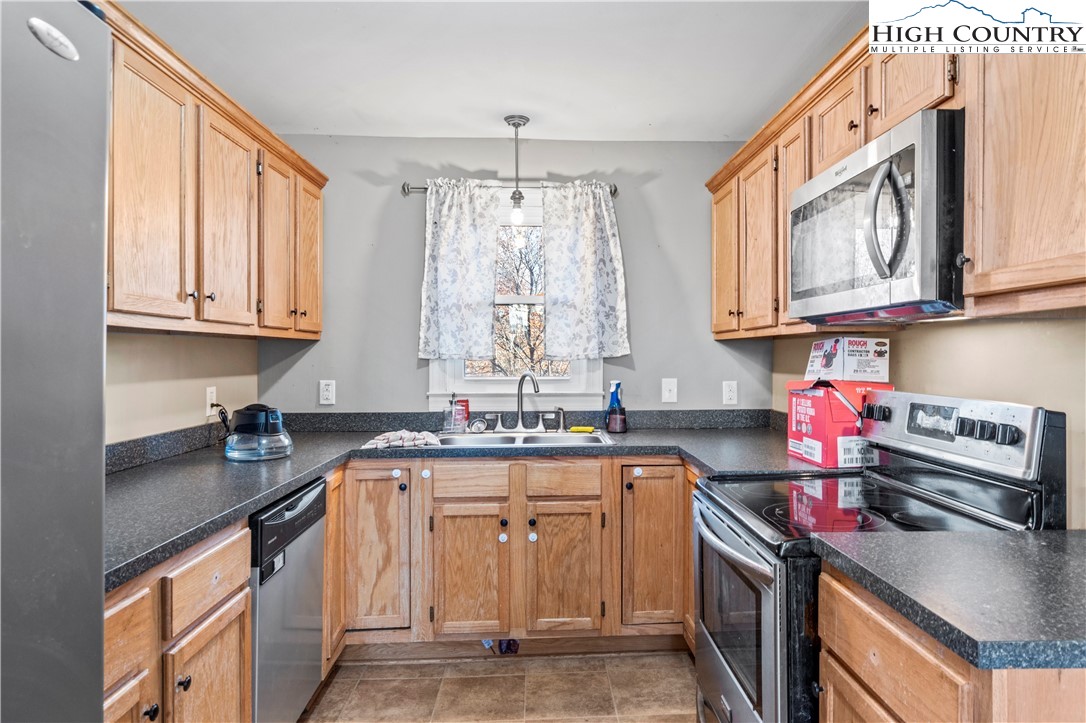 133 South Street Elkin, NC 28621 - Photo 8 of 24 a kitchen with stainless steel appliances granite countertop a sink stove and cabinets