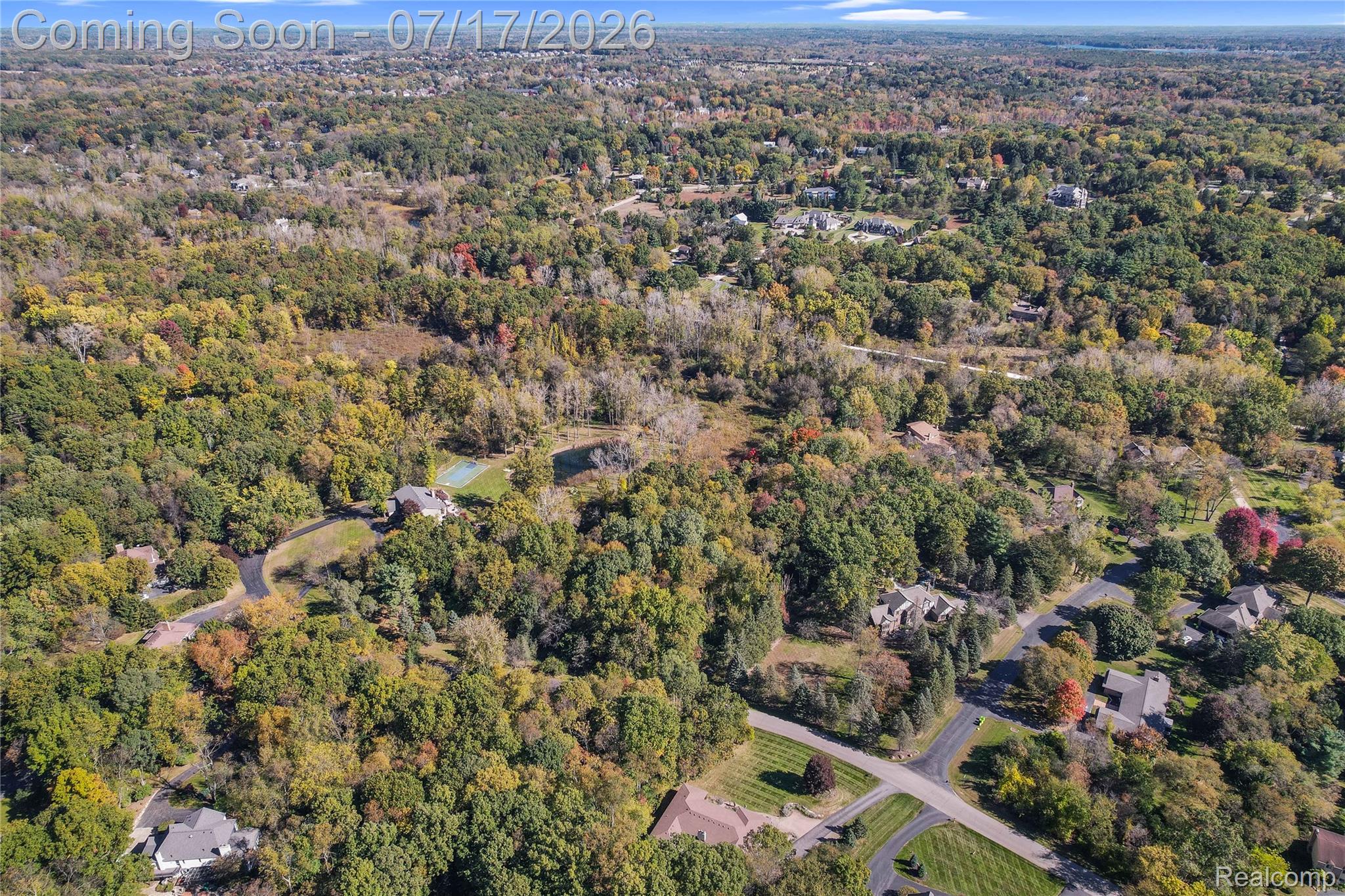 5685 Paint Valley Drive Rochester, MI 48306 - Photo 57 of 66 Expansive wooded landscape featuring a residential property with a private tennis court and asphalt driveway