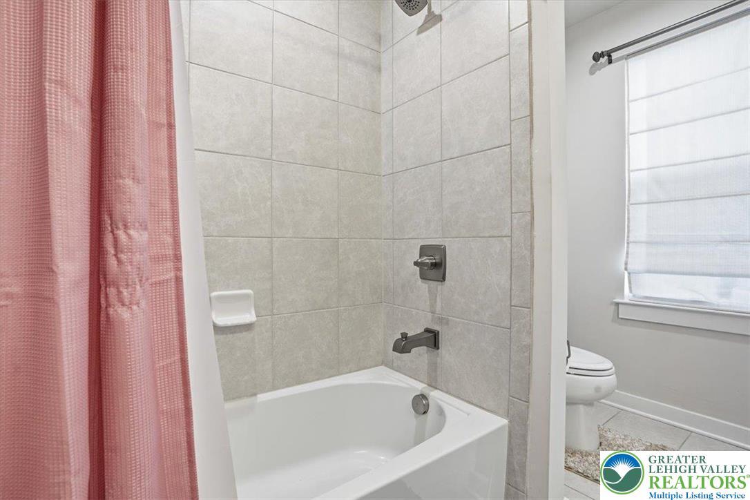 3902 Orth Street Bethlehem, PA 18020 - Photo 37 of 62 a bathroom with a bathtub and a toilet