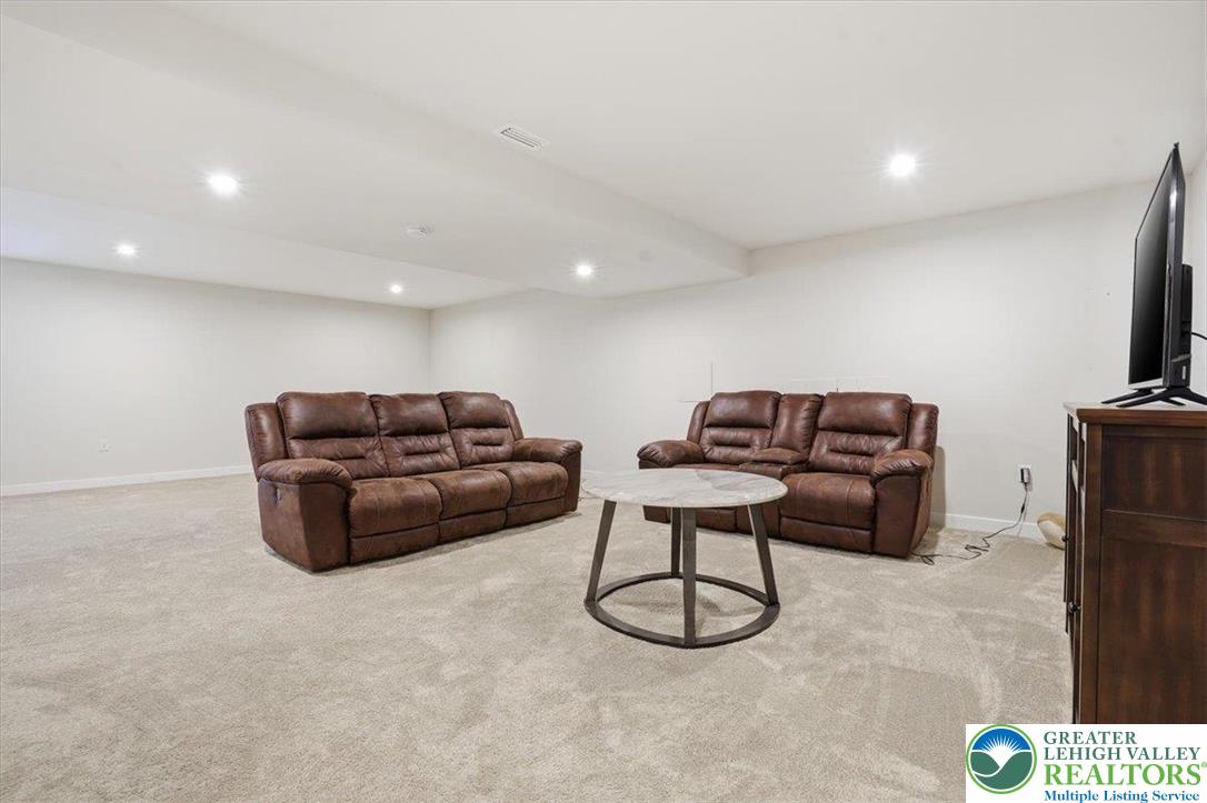 3902 Orth Street Bethlehem, PA 18020 - Photo 42 of 62 a living room with furniture a flat screen tv and a couch