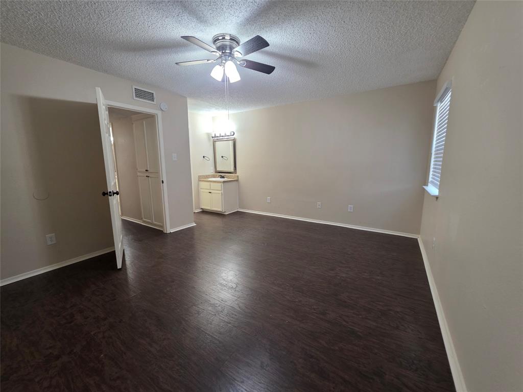 620 Race Street, Unit D Crowley, TX 76036 - Photo 14 of 20 an empty room with wooden floor chandelier fan and windows