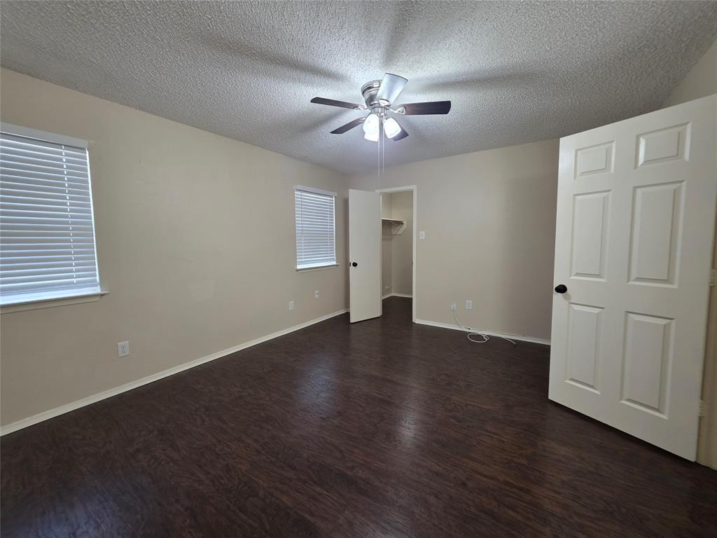 620 Race Street, Unit D Crowley, TX 76036 - Photo 17 of 20 a view of an empty room with wooden floor and a window