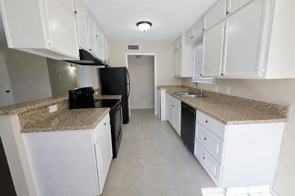 620 Race Street, Unit D Crowley, TX 76036 - Photo 2 of 20 a kitchen with stainless steel appliances granite countertop a sink stove and refrigerator