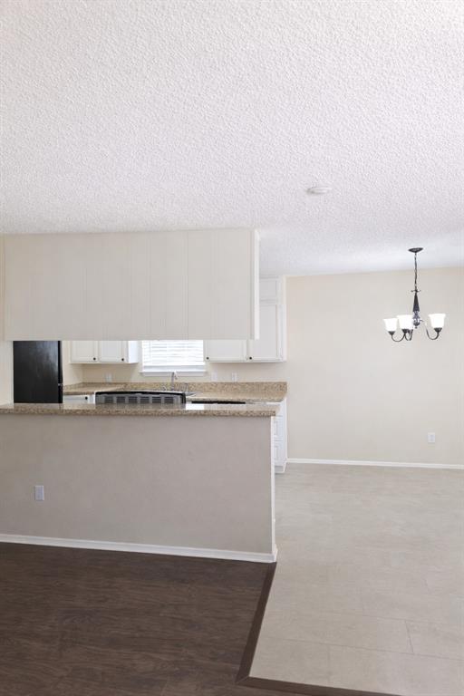 620 Race Street, Unit D Crowley, TX 76036 - Photo 6 of 20 a view of kitchen and wooden floor