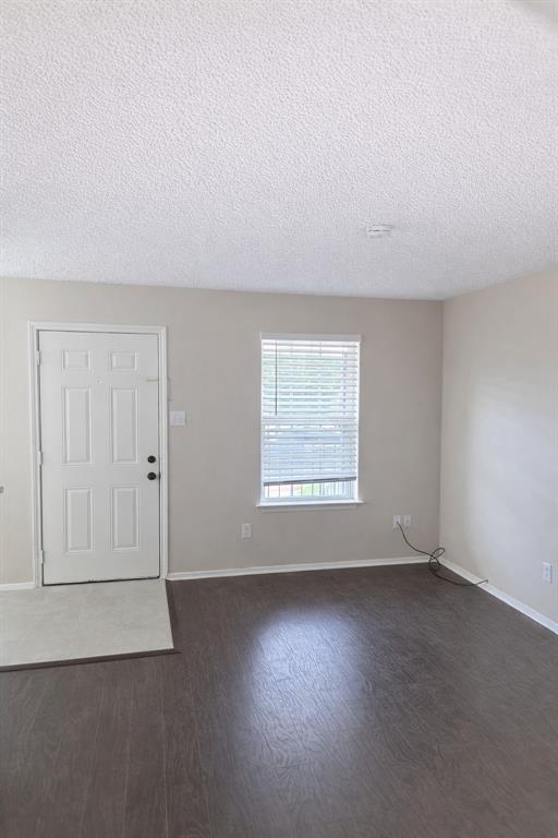 620 Race Street, Unit D Crowley, TX 76036 - Photo 7 of 20 an empty room with wooden floor and windows