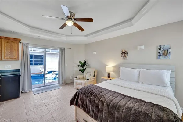 a bedroom with a balcony a bed and a table