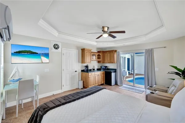 a bedroom with a bed and a chandelier