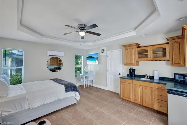 a bedroom with a large bed and a chandelier