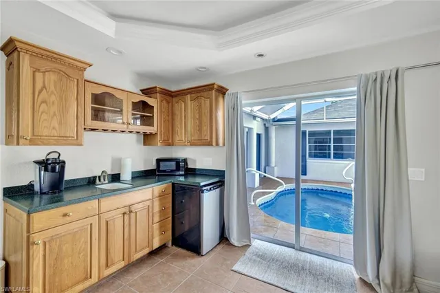 a kitchen with a sink a stove and cabinets