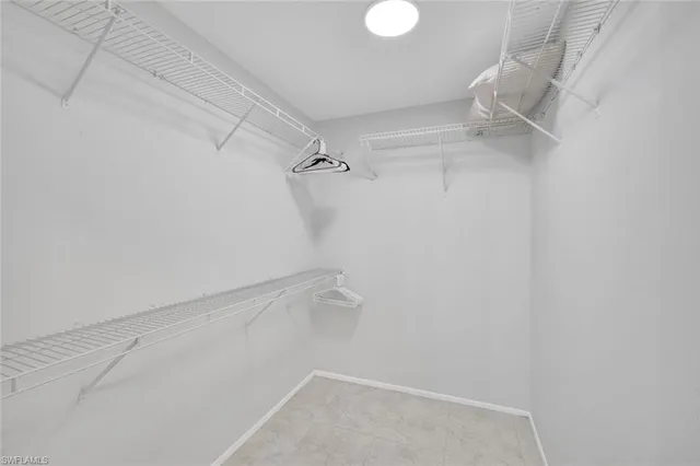 a view of walk in closet with empty racks