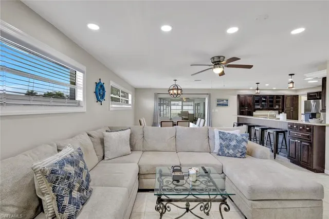 a living room with furniture and kitchen view