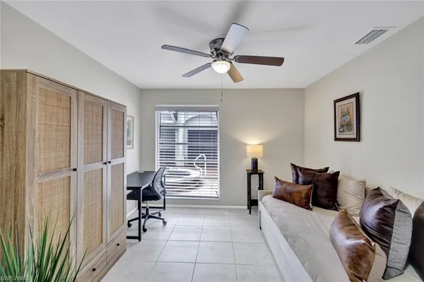 a bedroom with furniture and a window