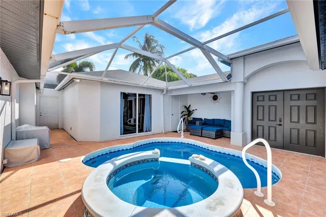 a view of a house with pool and chairs