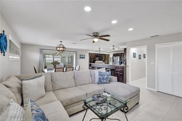a living room with furniture and a ceiling fan