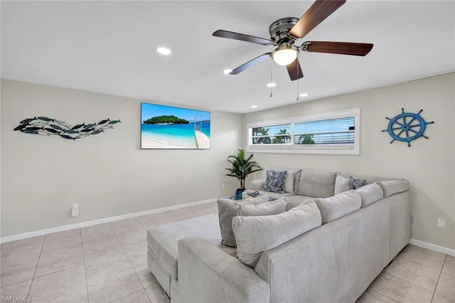 a living room with furniture and a ceiling fan