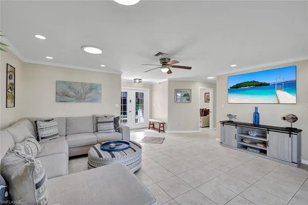 a living room with furniture and flowers