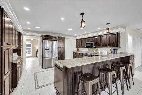 a kitchen with stainless steel appliances a sink stove and refrigerator