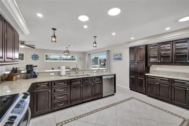 a large kitchen with stainless steel appliances granite countertop a stove and a sink