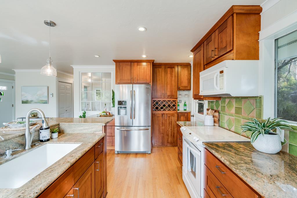 94 Robak Drive La Selva Beach, CA 95076 - Photo 5 of 24 a kitchen with stainless steel appliances granite countertop a sink a stove and a refrigerator